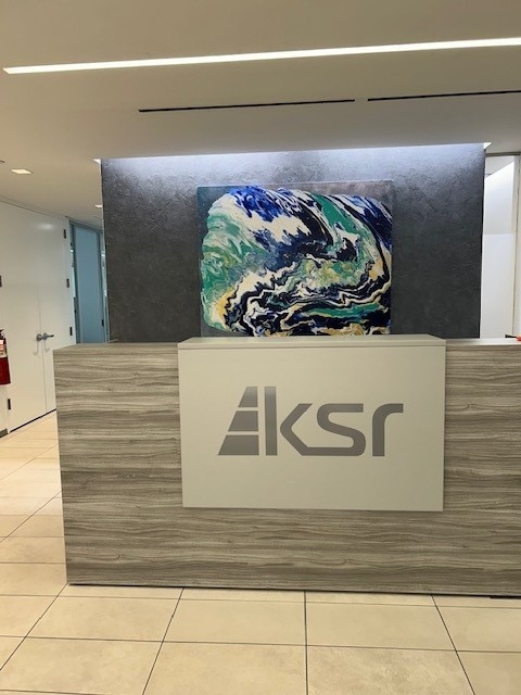 Silver dimensional logo at a reception desk