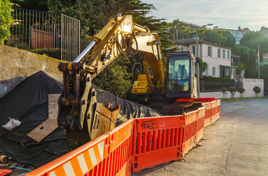 Construction site with orange barricades and safety signage