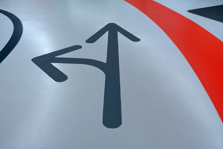 Floor graphic with directional arrows in commercial interior