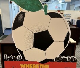 Soccer ball promotional display with Where the World Comes to Play NYC messaging