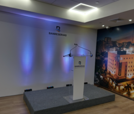 Bank podium with branded display and blue accent lighting in modern interior