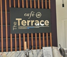Café at The Terrace entrance with wood slat feature wall and marble service counter